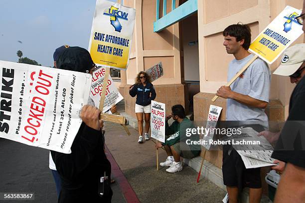 Outside the Ralphs market on Warner Ave. In Huntington Beach striking workers hold signs at the entrance during the third week of the strike.