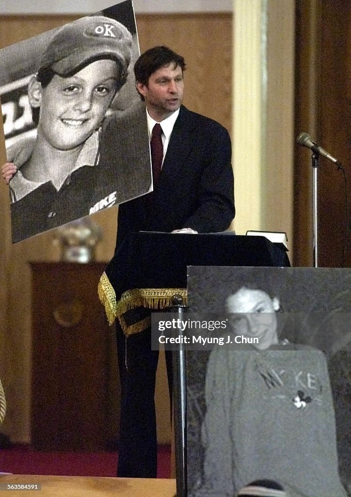 Rabbi Dovid (cq) Fischer, President of the Zionist Organization of America, holds pictures of 13yea