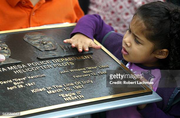 At the dedication ceremony of the city Costa Mesa KetchumLibolt Park, Kiah Williams of Seattle touches the plaque which was unveiled for her...