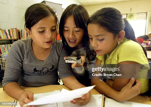 Sendy Rivas Ellie Wen, center, records Sendy Rivas, left, read a poem as... News ...