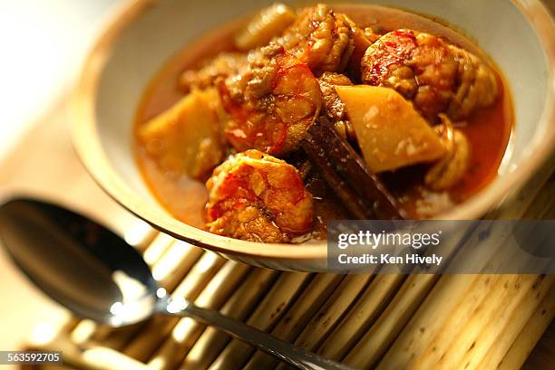 Cover story about curries. Photo of Ingredients that are common to all the curries. Shrimp vindaloo.