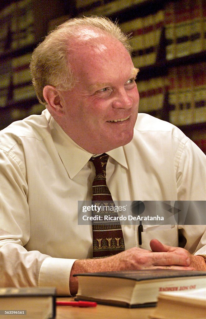 Sr. Deputy District Attorney Bill Redmond smiling after a legal research in the DA's legal library a