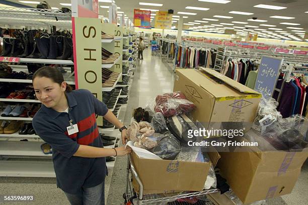 Shoppers shop at the Ross Dress for Less store in Pico Rivera shop on 11/14/75. CYNTHIA URIAS IS BEGINNING TO STOCK THE SHELVES WITH ACCESSORIES.