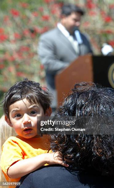 Izzy Jaquez 2, sits on his mother Laura's lap as Oxnard police detective Manuel Vega shares his experience of being abused as a child by a priest....