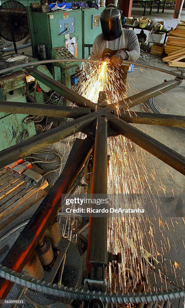 Iron worker Juan Cabanillas welding a hoop made for CalTrans at Franklin Reinforcing Steel Company. 