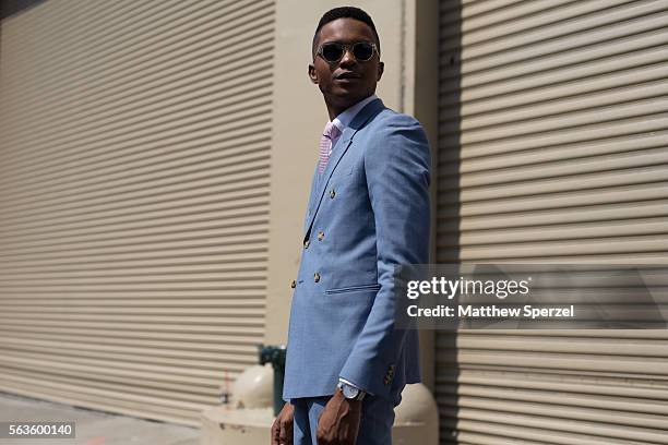 Igee Okafor is seen attending the Nick Graham, Kenneth Ning & John Elliott presentations wearing a Topman suit and tie, Frank & Oak shirt, Frank...