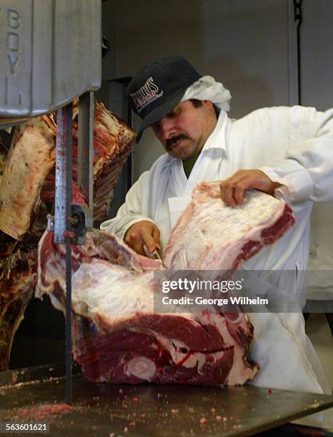 Sonny Cabrales, manager of Harmony Farms, carves up a side of beef. Harmony Farms is a tiny oldfashioned, meat shop in La Crescenta which sells...