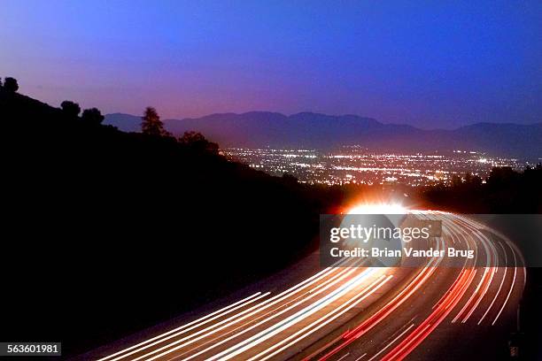 Looking northbound along the 405 freeway in the Sepulveda Pass, a view of the lights of the San Fernando Valley opens up from the bridge at...