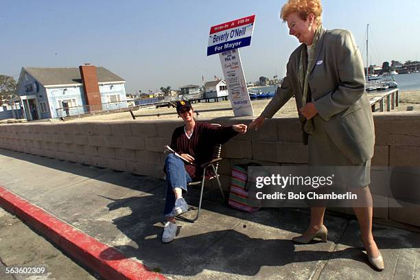 Long Beach Mayor Beverly O'Neil reaches out to thank her daughter Teresa O'Neil who was sitting with the mayor's sign over 100 feet from "LeeWay...