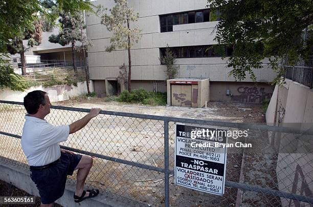 Tim Flynn looks over the abandoned St. John's hospital building in Oxnard. Flynn, who lives down the street, is hopeful about plans to convert the...