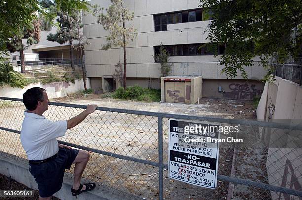 Tim Flynn looks over the abandoned St. John's hospital building in Oxnard. Flynn, who lives down the street, is hopeful about plans to convert the...