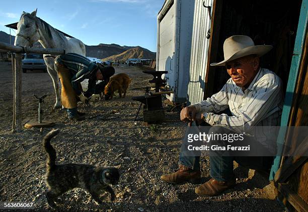Howard Blair takes a break from afternoon chores while his son, Rob, fixes a horse shoe on 14yearold Pepper. The Blair Ranch is one of the last...