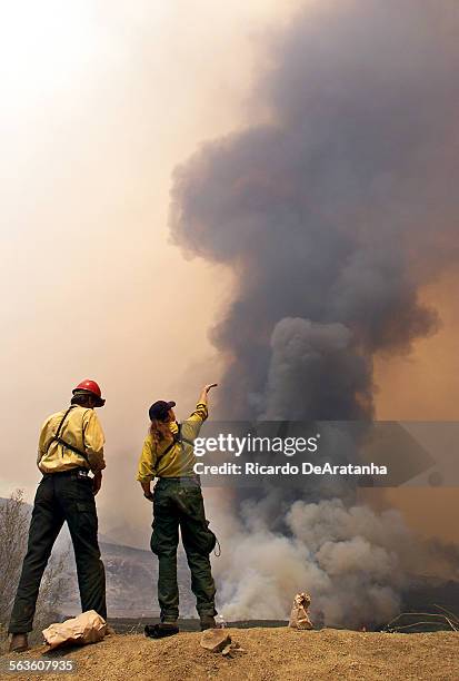 Steve Bello of the U.S. Forest Service, left, and Holly Maloney, of Lolo Hot Spots forest service, monitoring the Wolf fire in the Sespe Wilderness.