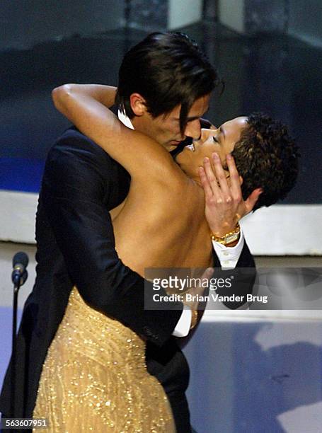 Actor Adrien Brody suprises presenter Halle Berry with a kiss after he won the Oscar for best actor for his work in "The Pianist" at the 75th annual...