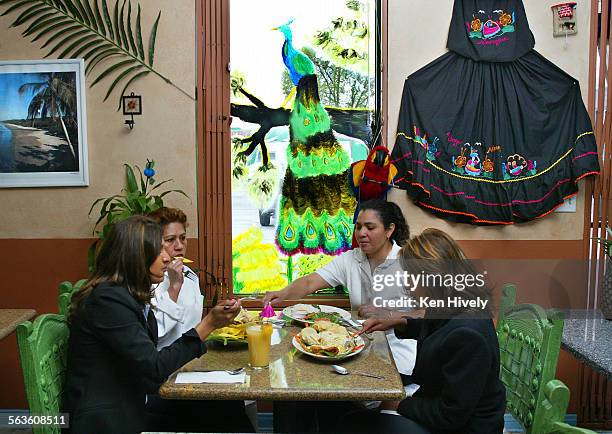 El Nido is a Nicaraguan restaurant with granitetopped tables, decorated with snapshots of Nicaragua, whimsical stuffed parrots. Photo of interior...