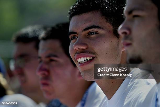 Luis Gaona Jr., a senior at North High School sits in the stands of Wheelock Stadium during the celebration of the completion of the Passport to...