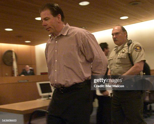 Michael Schultz, left, accused of raping and strangling a Port Hueneme woman in her condominium, is lead out of courtroom at Ventura county...