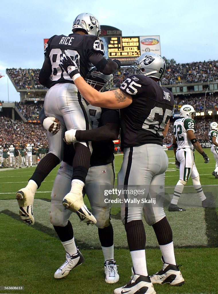 Raiders receiver Jerry Rice is hoisted after making a touchdown catch ...