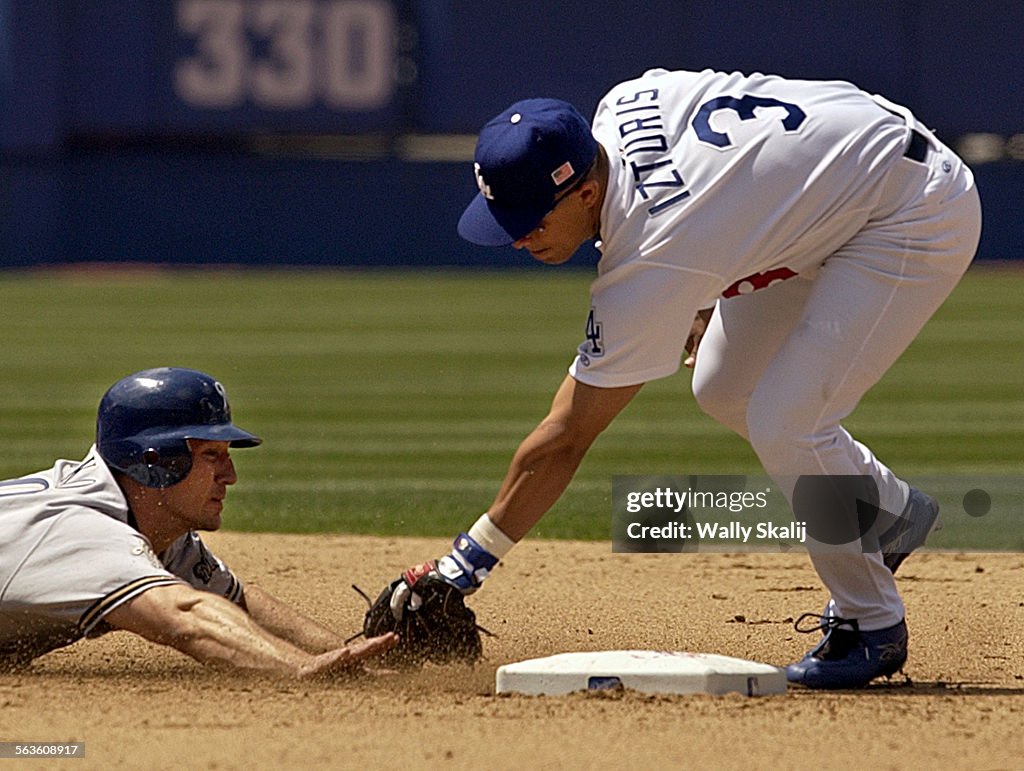 Dodgers shortstop Cesar Izturis tags out Brewers Paul Bako after being picked off at second base by 