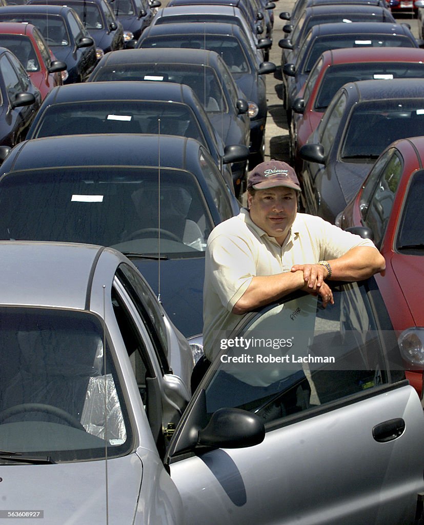 (Huntington Beach, CA) John Haddad, owner of Daewoo/Kia of Huntington Beach is photographed with Dae