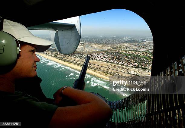 Burbank, Santa AnaLiz Minichino, of Placerville, Ca., views the Orange County coastline from the machine gun window of the only B24 Liberator...
