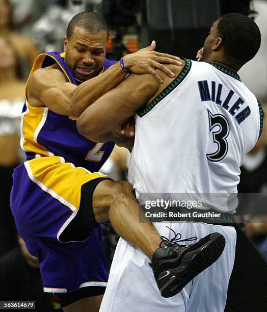 Los Angeles Lakers guard Derek Fisher runs into a hard screen from Minnesota Timberwolves center Oliver Miller during game 2 of the Western...