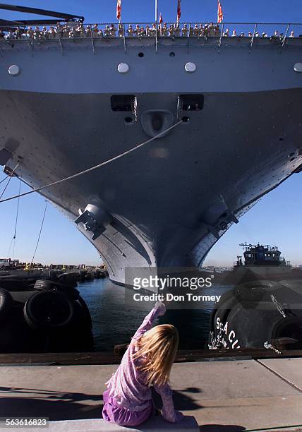 Baylee Bincent of San Deigo, waves goodbye to her daddy,a sailor onboard the USS Boxer, as it leaves San Diego Harbor Friday Jan. 17 as part of a...