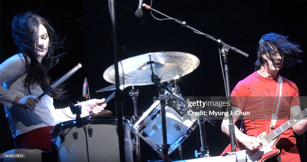 Meg White (left) and Jack White of The White Stripes perform Sunday night at the Coachella Valley Mu
