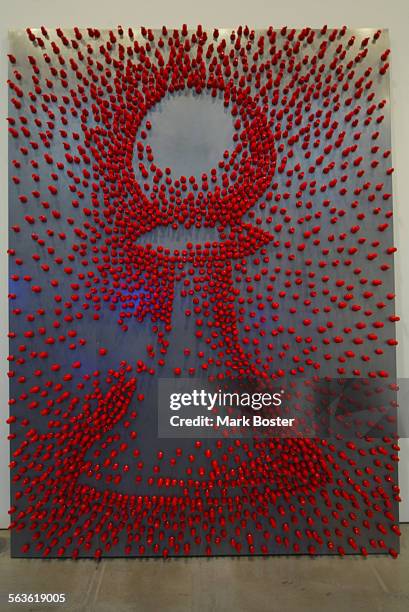 Picture of the "Pawn", 1991 made of 2500 redplastic magnetic chess piecesexcept for the pawn. The pieces were assembled on a stainless steel board...