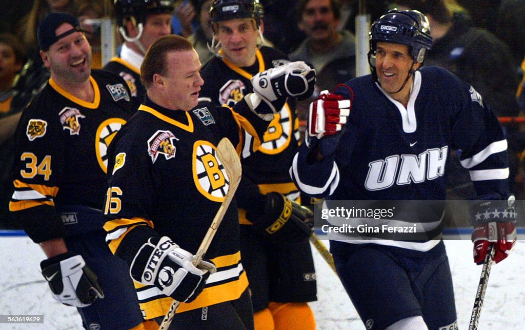 Democratic presidential hopeful John Kerry gets congratulations from teammates after scoring his sec