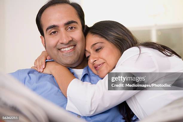 portrait of a mid adult man smiling with a mid adult woman - geheimratsecke stock-fotos und bilder