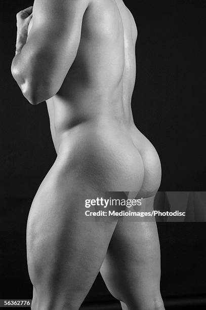 side profile of a young man standing - male buttocks stockfoto's en -beelden