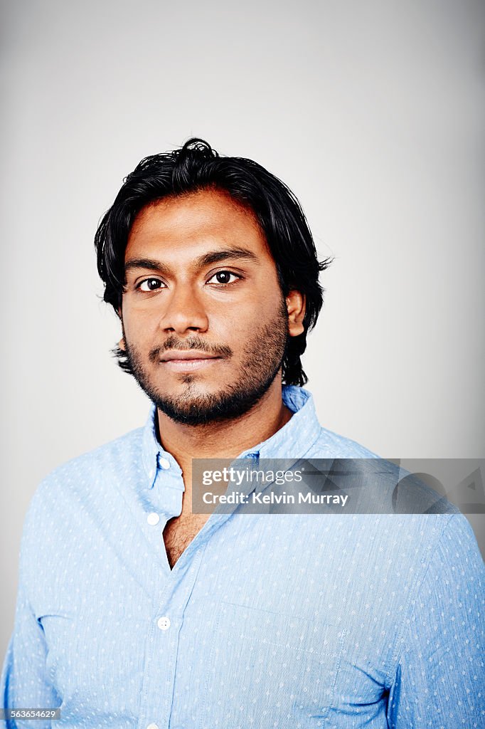 Studio portrait of a man wearing a blue shirt