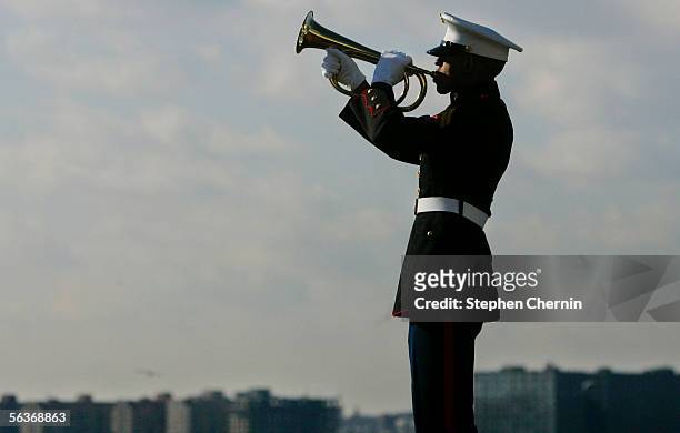 Marine Corps bugler plays taps during a ceremony on the USS Intrepid Air and Space Museum December 7, 2005 in New York City. Pearl Harbor survivors...