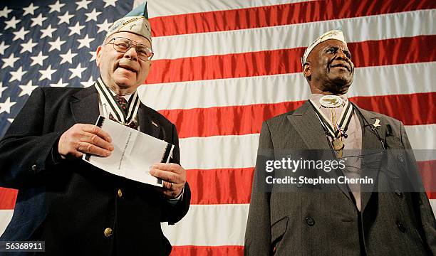 Pearl Harbor survivors Daniel S. Fruchter and Clark J. Simmons , who was on the USS Utah, stand before a U.S. Flag on the USS Intrepid Air and Space...