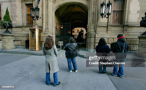 Fans stand in front of the Dakota apartments where John Lennon was murdered December 7, 2005 next to Central Park in New York City. Lennon was killed...