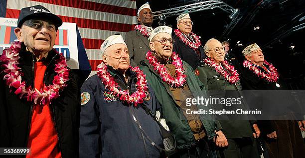 Survivors of the Pearl Harbor attack stand with orchid leis from Oahu, Hawaii, around their necks on the USS Intrepid Air and Space Museum December...