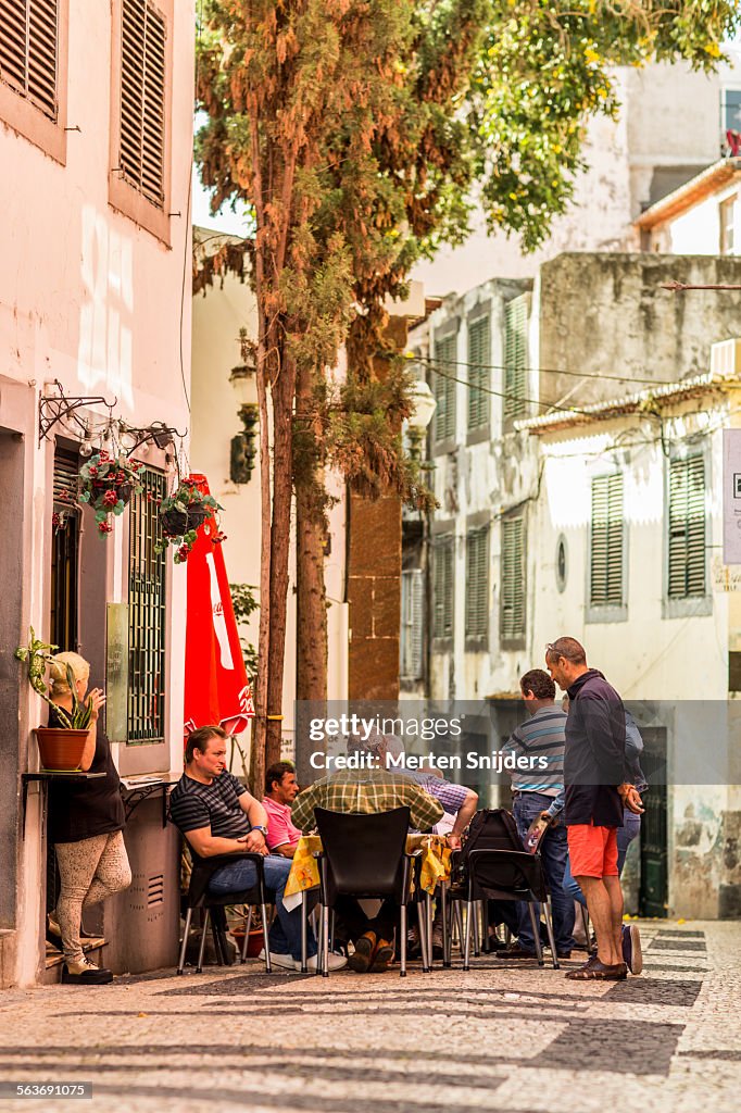 Local gathering in alley during morning