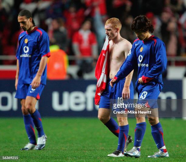 Dejected Manchester United players Rio Ferdinand, Paul Scholes and Ji-Sung Park trudge off the pitch having been eliminated from the Champions League...