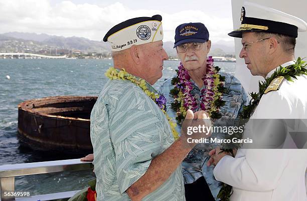 With the submerged smoke stack of the USS Arizona looming in the background, Pearl Harbor survivors Lou Conter, Ward Witmore, and current US Pacific...