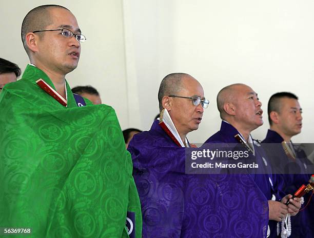 Japanese Buddists monks chant while standing in front of the memorial wall aboard the USS Arizona honoring the Pearl Harbor dead during the ceremony...