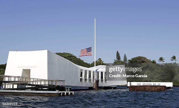 Flag flies at half mast aboard the USS Arizona Memorial during the ceremony honoring the 64th anniversary of the surprise attack on Pearl Harbor,...