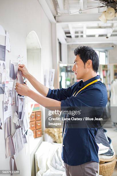 fashion designer working in studio - holding-glue-stick stock pictures, royalty-free photos & images