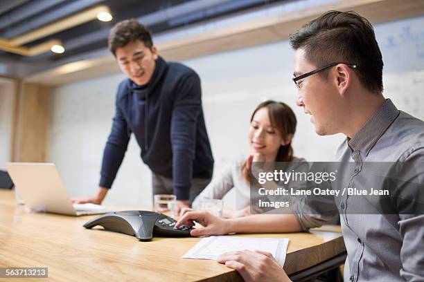 business people having teleconference in board room - conference phone stock pictures, royalty-free photos & images