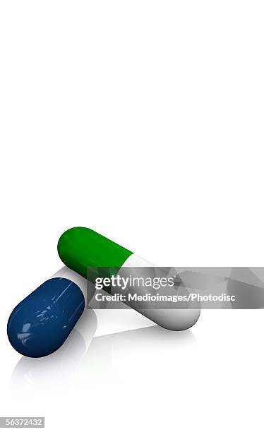 close-up of two capsule - tablet white background stock illustrations