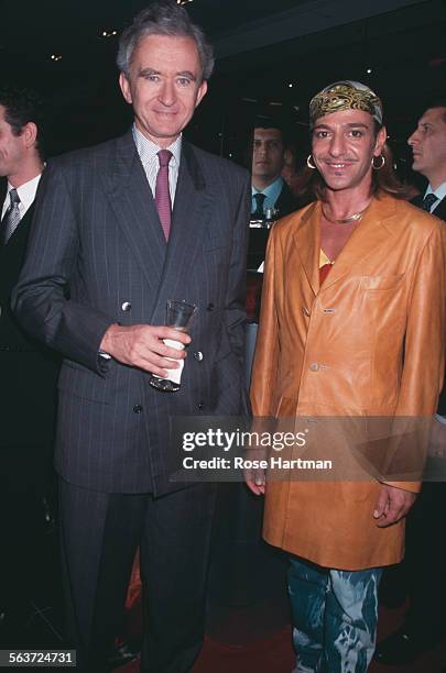 French business magnate and Chief Executive Officer of LVMH, Bernard Arnault, and British fashion designer, John Galliano, attend the Sephora store...