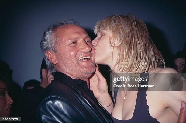 Italian fashion designer, Gianni Versace and American singer and musician Courtney Love at the Versus by Versace Fall Collection fashion show, circa...