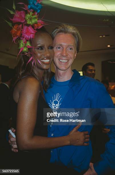 Somali-American fashion model, Iman and Irish hat designer, Philip Treacy, attending a party held at Bergdorf Goodman, New York City, circa 2000.