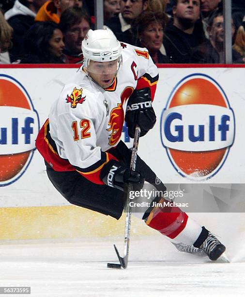 Right wing Jarome Iginla of the Calgary Flames skates with the puck against the New Jersey Devils during their game on December 7, 2005 at...