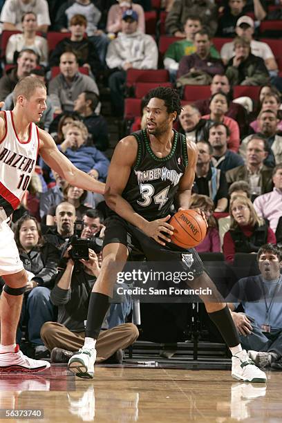 Michael Olowokandi of the Minnesota Timberwolves looks for an opening around Joel Przybilla of the Portland Trail Blazers during a game on December...